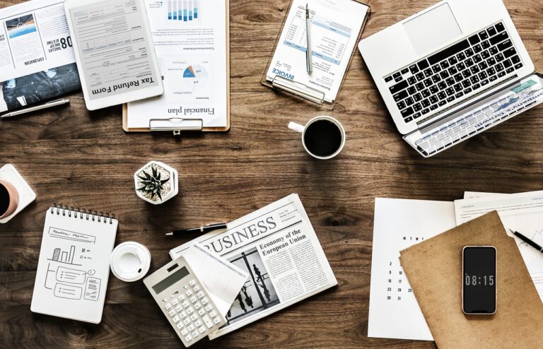 notebook, computer and other documents on a desk